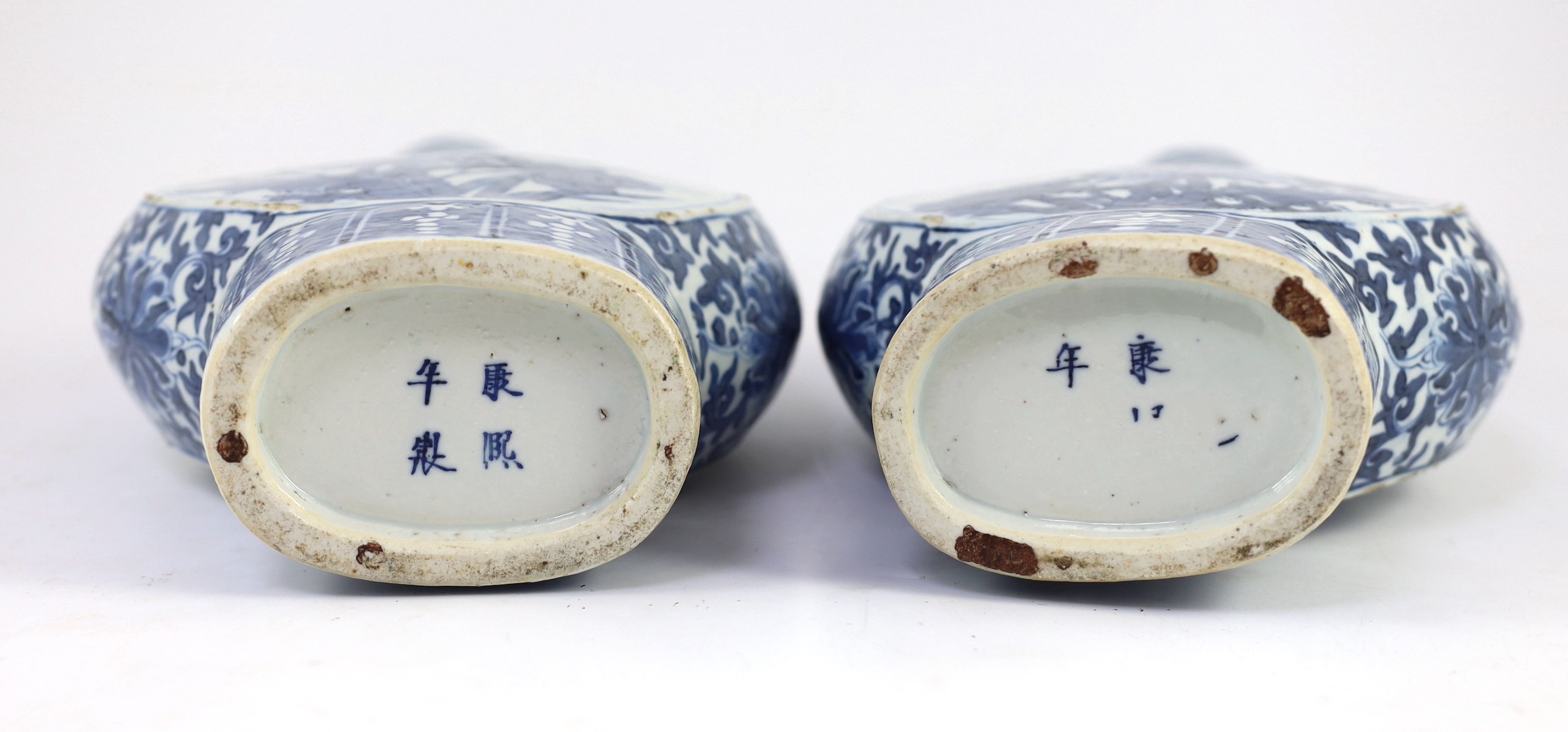 A pair of Chinese blue and white moon flasks, 19th century, 30cm high, small glaze losses and firing cracks